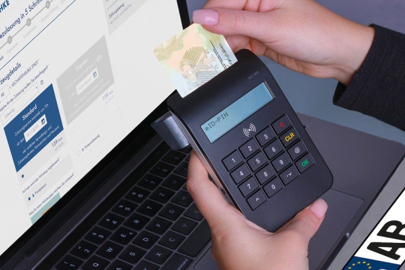 a person useing swipe card machine for payment